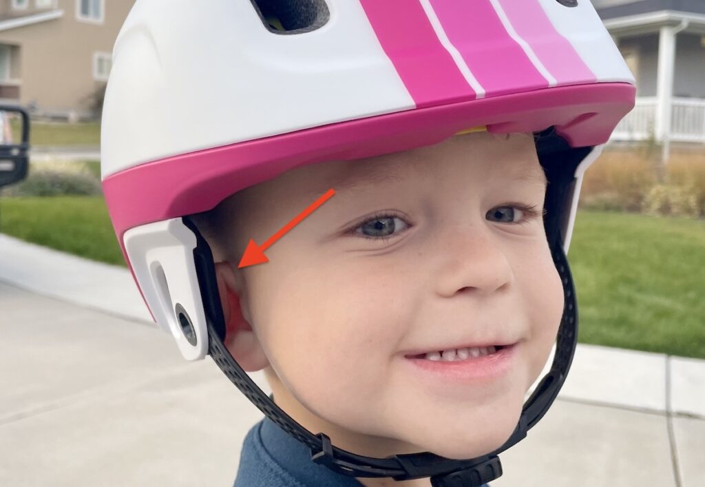 child wearing a highbar helmet with his ear folded down