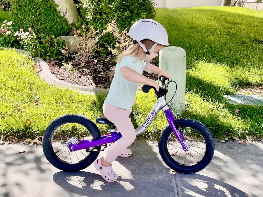 2 year old in 2T clothes on small littlebig balance bike