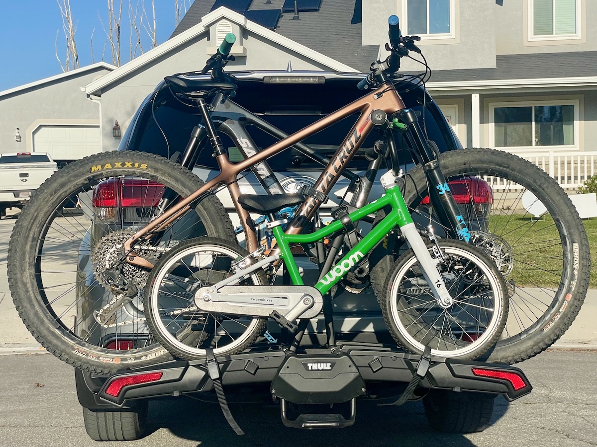 thule epos foldable bike rack loaded with mountain bikes and kids bike
