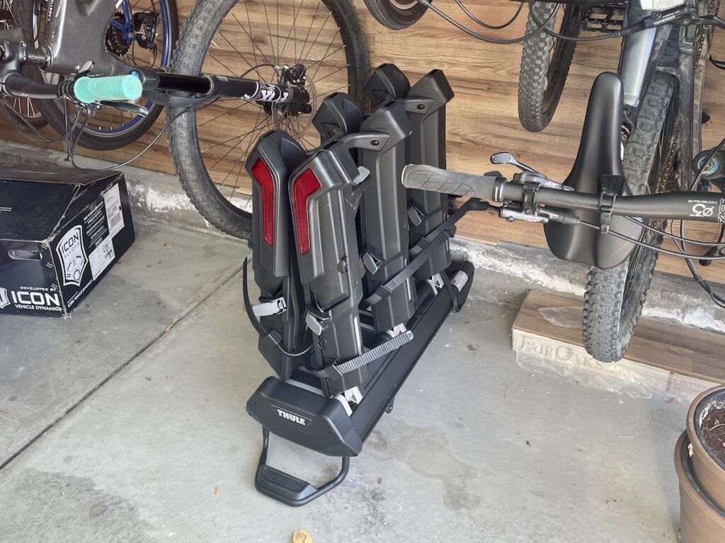 thule epos hitch rack folded in a garage