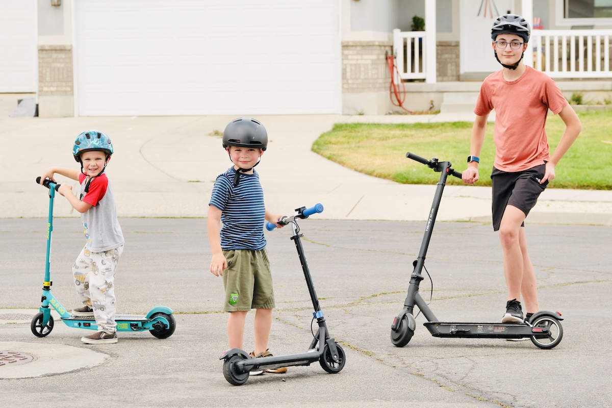 3 kids testing out electric scooters
