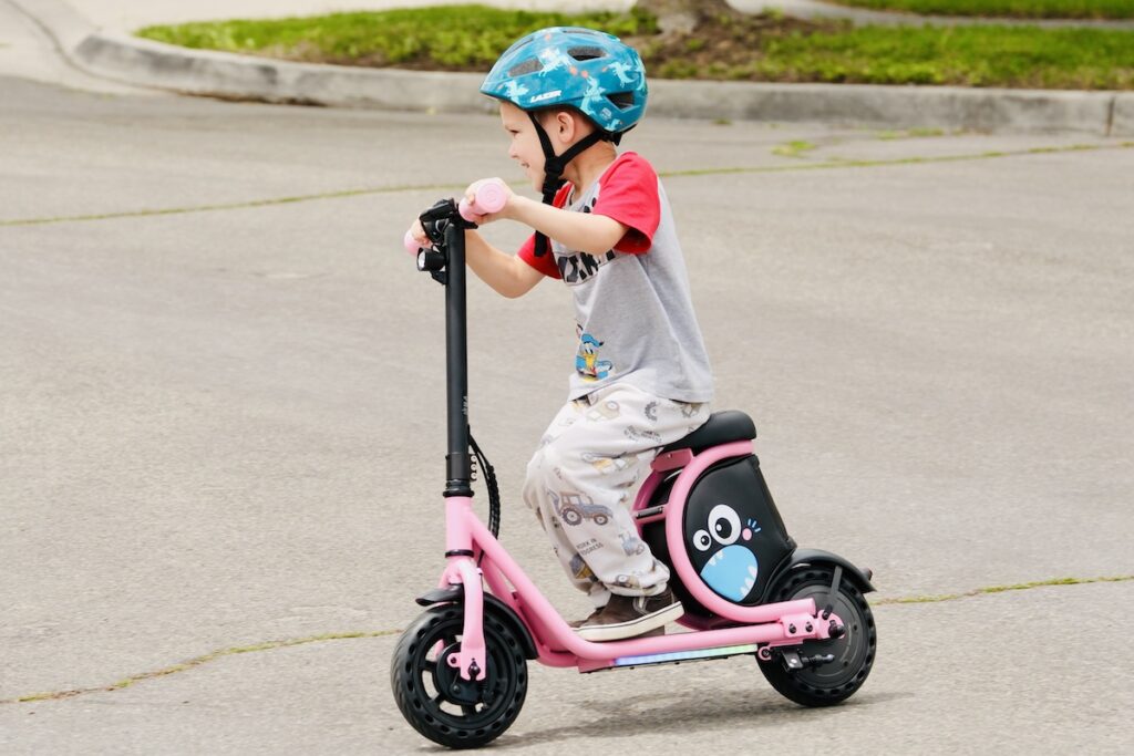 child riding the hiboy electric scooter with seat